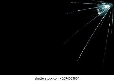 a crack on a broken glass mirror on a black background lines fragments bullet hole - Powered by Shutterstock