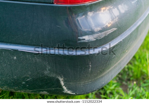 A crack on the bumper of the car. A shabby car\
bumper. A road accident.