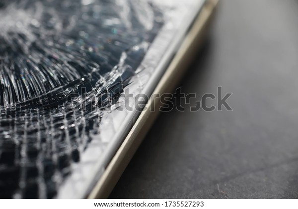 Crack on the glass.\
Broken screen. Broken phone. Cracked glass background. White cracks\
in glass.