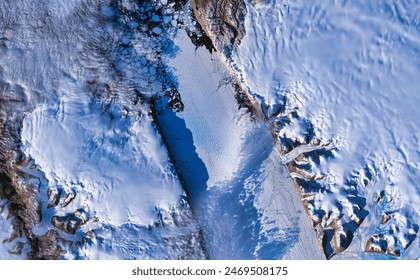 Crack in the Petermann Glacier. The Advanced Spaceborne Thermal Emission and Reflection Radiometer ASTER on  s Terra satellite captured this  Elements of this image furnished by NASA. - Powered by Shutterstock