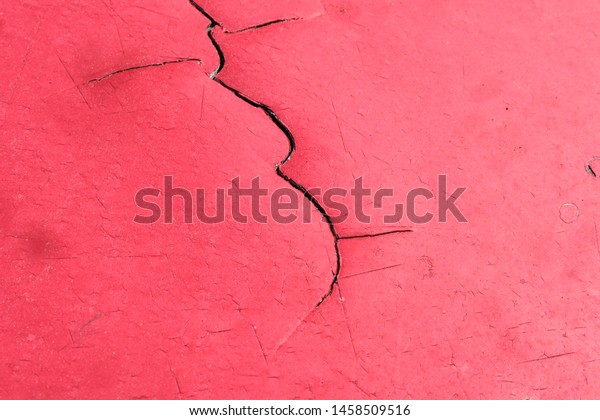 Crack red metal, peeling paint color, damage of sun
burn on old car