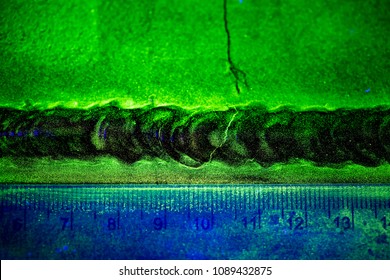 Crack steel butt weld carbon background green contrast of magnetic filed fluorescent test
