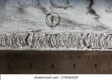 Crack steel butt weld carbon background white contrast of magnetic field test and ruler transverse crack defect scale - Shutterstock ID 1745463329