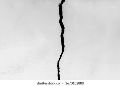 Crack in the white wall. The concept of schism or contradiction.