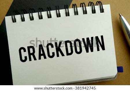 Crackdown memo written on a notebook with pen