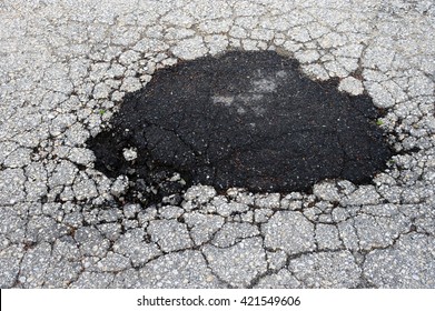 Cracked Asphalt Road Surface And Repair Patch