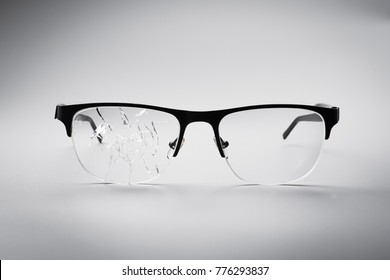 Cracked Black Eye Glasses On A White Background