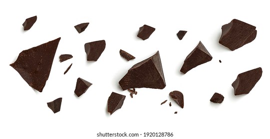 Cracked broken chocolates, chocolate chips morsels or chocolate parts from top view isolated on white background