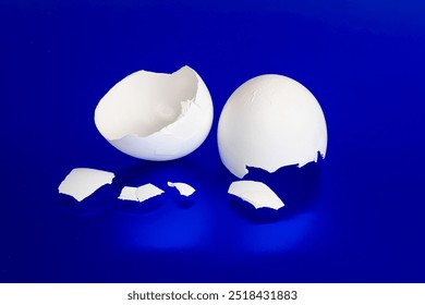 Cracked Broken Egg Shells Blue Background - Powered by Shutterstock