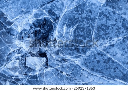Cracked and broken ice background texture. Frozen lake ice. Ice surface