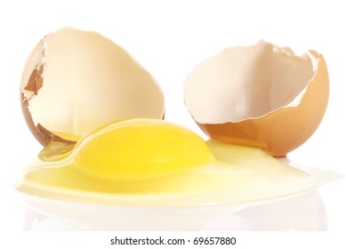 Cracked Brown Egg, With Yolk Spilling On White Background