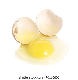 Cracked Brown Egg, With Yolk Spilling On White Background