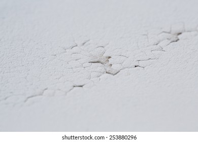 A Cracked Ceiling With Peeling Layer Due To Water Leak