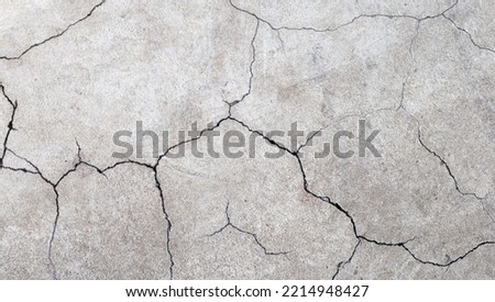 Cracked cement or concrete surface texture for background.