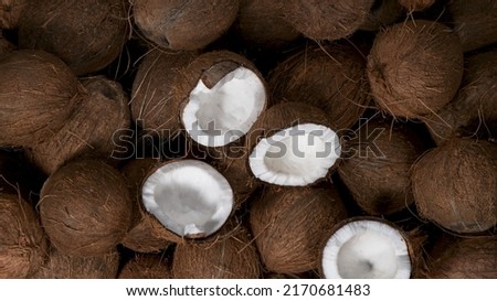 Cracked coconuts falling, freeze motion, top down view