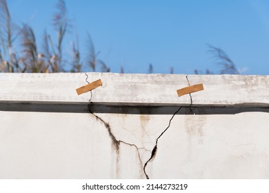 Cracked concrete parapet with adhesive. - Shutterstock ID 2144273219
