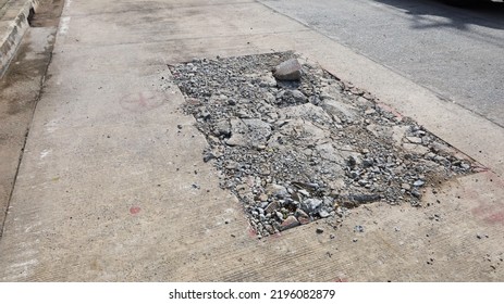 Cracked Concrete Road Surface. Cement Roads Damaged By Drilling Rectangular Shapes To Lay Urban Underground Drainage And Power Lines With Copy Spaces. Selective Focus 