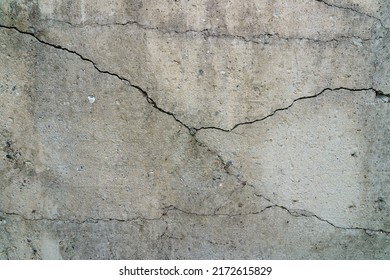 Cracked Concrete Slab. Wall Made Of Cement With A Crack. House Foundation Repair. Texture Surface Or Background