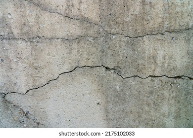 Cracked Concrete Slab. Wall Made Of Cement With A Crack. House Foundation Repair. Texture Surface Or Background