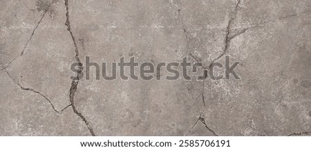 Cracked concrete surface with a linear pattern, illuminated by natural light