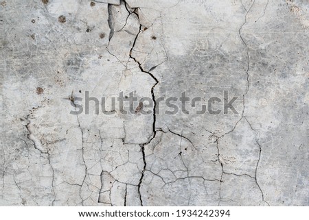 Cracked concrete. Concrete texture with cracks. Gray asphalt. The old texture is broken.