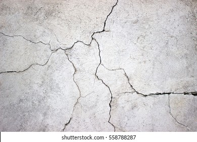 cracked concrete wall covered with gray cement surface as background - Shutterstock ID 558788287