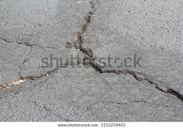cracked and damaged parking lot or driveway need for\
repairing \
