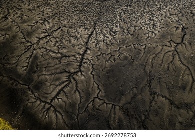 Cracked dried mud texture pattern aerial view mining sediment natural erosion abstract geometric industrial landscape brown earth environmental