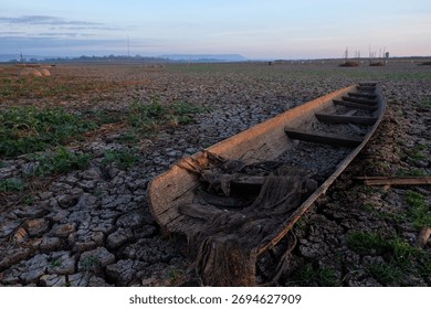 The cracked and dry surface of the dam is devoid of water due to the lack of rain due to natural drought.