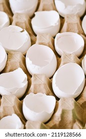 Cracked Egg Shells In A Carton Container. Close Up.