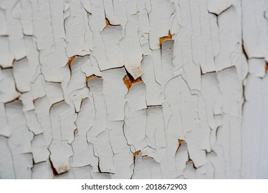 Cracked flaking white paint, background texture