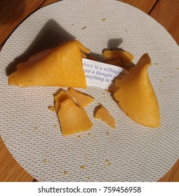 Cracked Fortune Cookie On White Table Cloth  