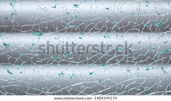 Cracked glass closeup.\
Beautiful background texture with cracks on the glass. Spiderweb\
from cracks.