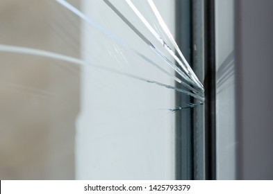 Cracked glass. Plastic window is damaged by cracks.