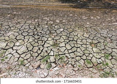 The Cracked Ground In The Dry Season Of The River That Is Dry By The Heat.
Arid Land With Cracks In The Soil Because Of The Heat During The Dry Season And Global Warming That Is Increasing Every Year.