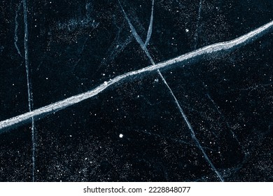 Cracked ice texture background. The textured cold frosty surface of the ice on black background. - Shutterstock ID 2228848077