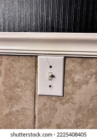 Cracked Light Switch Cover On A Bathroom That Is Being Remodeled.