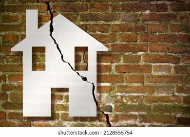 Cracked old and aged broken brick wall with a house drawn on it - concept image