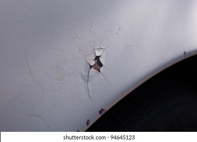Cracked paint on car fender.