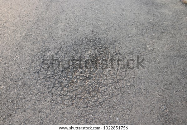 Cracked road, damaged asphalt
road