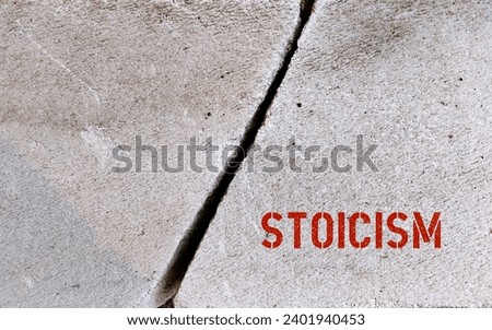 Cracked rock with text inscription Stoicism, to attain inner peace by overcoming adversity, practicing self-control, being conscious of our impulse