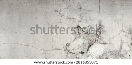 Cracked and spalling concrete surface with exposed substrate