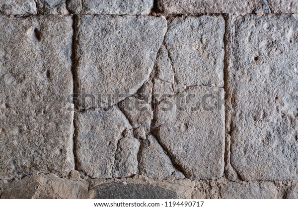 cracked stone blocks, antique tiled stone floor / wall\
with cracks -