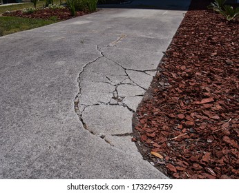 Cracked sunken concrete driveway repair  - Shutterstock ID 1732964759