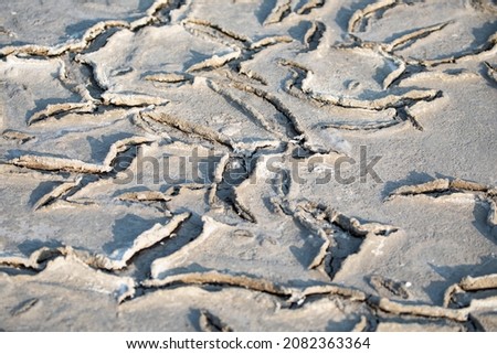 the cracked surface of the dried lake bottom is very closeup. pattern. natural texture of cracked clay in perspective floor. Selective focus on black soil dark land. 