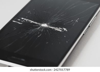 Cracked torn smartphone screen close-up. Broken display.