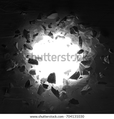 cracked wall with hole and debris in low key