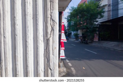 Cracked White Pillar Column Near Street