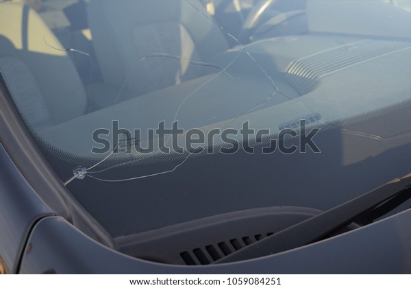 Cracked windshield on the car -\
Guardian logo - close up - Kongsvinger, Norway (1th April\
2018)