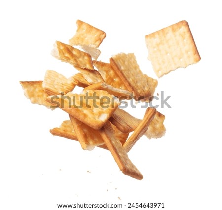 Cracker Butter square fall fly in mid air, golden crispy cracker Butter square floating. Cracker Butter crack crunch throw in air. White background isolated freeze motion high speed shutter